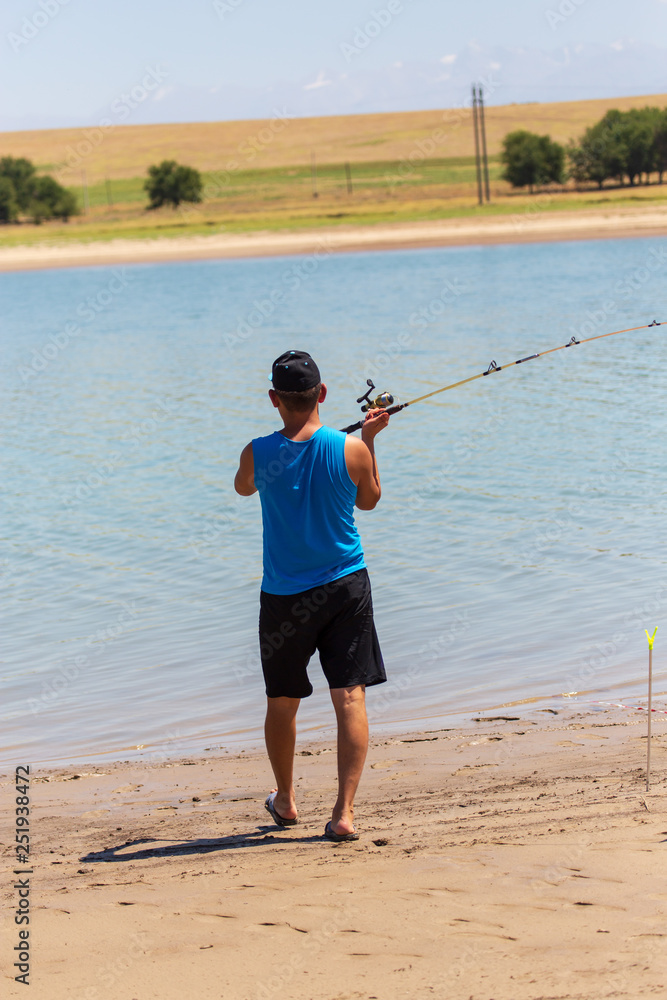 A man catches fish on the lake A man catches fish on the lake