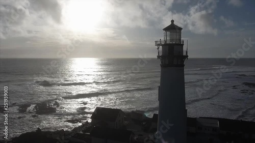 Close up  of the lighthouse on the coast in the pacific ocean, very cinematic, aerial shot