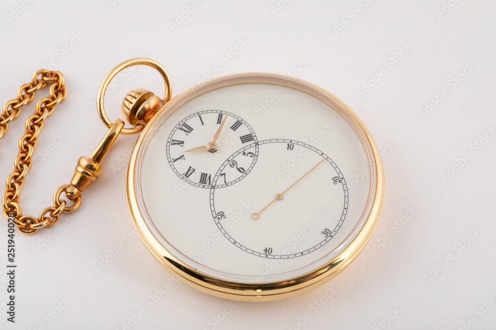 Round hand held , gold-tone watch with white dial and black numerals and gold hands on gold chain isolated on white background.