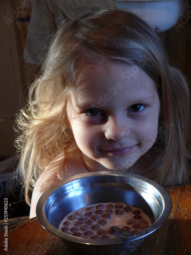 little girl with a bowl of milk and Breakfast powder