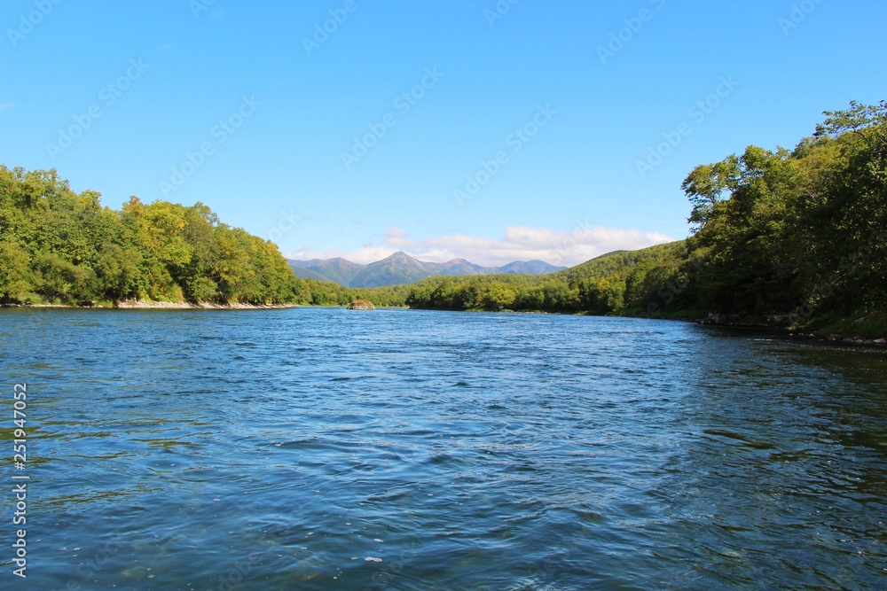 Beautiful Bystraya Malkinskaya river flows in valley between hills on the Kamchatka Peninsula, Russia. Beautiful Bystraya Malkinskaya river flows in valley between hills on the Kamchatka Peninsula, Russia.