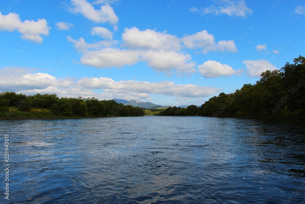 Beautiful Bystraya Malkinskaya river flows in valley between hills on the Kamchatka Peninsula, Russia.