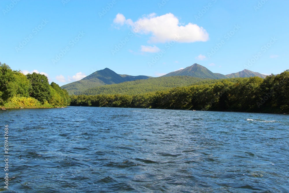 Beautiful Bystraya Malkinskaya river flows in valley between hills on the Kamchatka Peninsula, Russia.