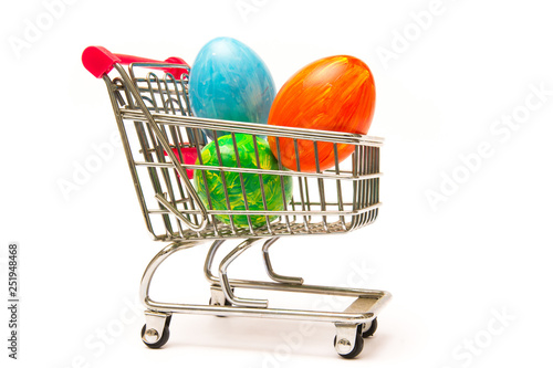 Easter shopping. Handmade colored eggs in cart. Business and selling in spring