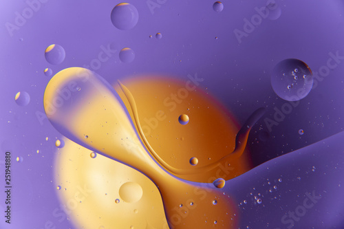 abstract background of colored drops of oil on the water