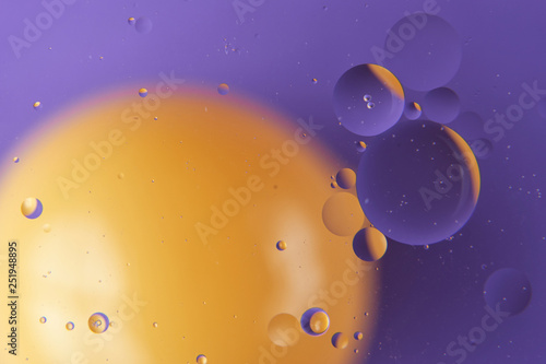 abstract background of colored drops of oil on the water