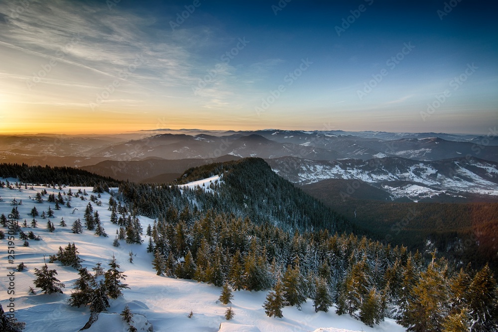 Sunrise above the mountain peaks, view from Ceahlau mountains, Romania.