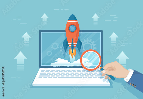 Rocket launch from laptop screen. Business project startup, financial planning, idea development process, strategy, management, realization and success. Hand with magnifying glass