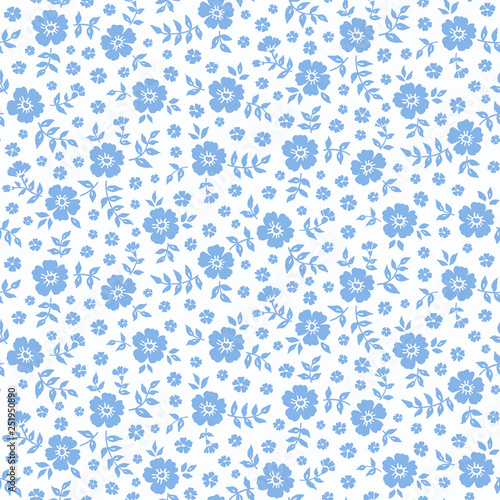 Seamless ditsy floral pattern in vector. Small blue flowers on a white background.