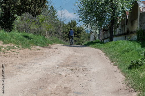 Wallpaper Mural A man riding a bicycle on the driveway in the park. Torontodigital.ca