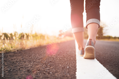 Closeup woman walking towards on the road side. Step concept.