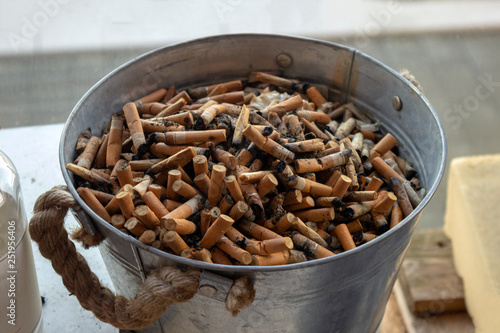 Cigarette butts background. Ashtray on the belcony photo