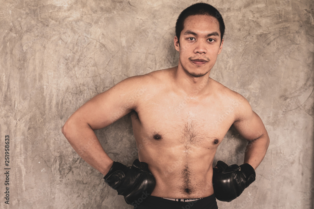 Portrait of  sportsman in boxing gloves on grunge background