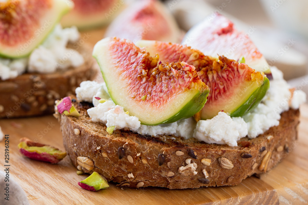 Slices of bread with cheese and fresh figs Slices of bread with cheese and fresh figs