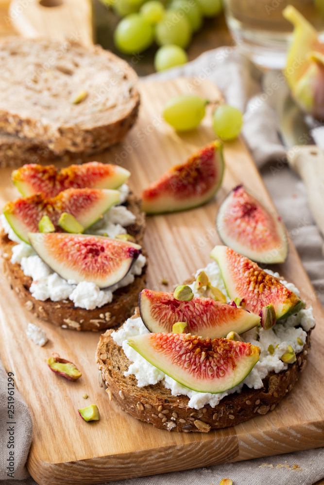 Slices of bread with cheese and fresh figs Slices of bread with cheese and fresh figs