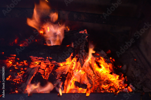 Smoldering ashes of a bonfire. Fire flame in a brick barbecue