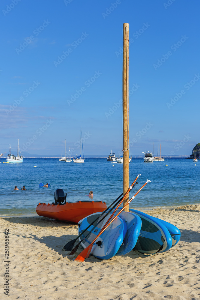 colorful surfboards on a sandy beach on the coast of the Spanish resort of Magaluf colorful surfboards on a sandy beach on the coast of the Spanish resort of Magaluf
