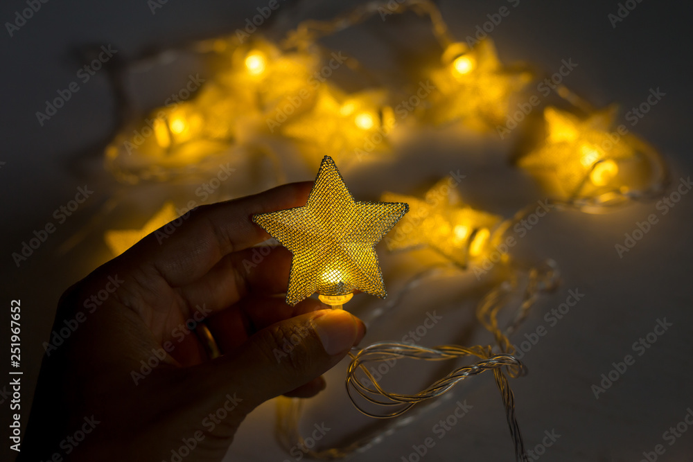 Hand holding christmas lamp star on white background Hand holding christmas lamp star on white background