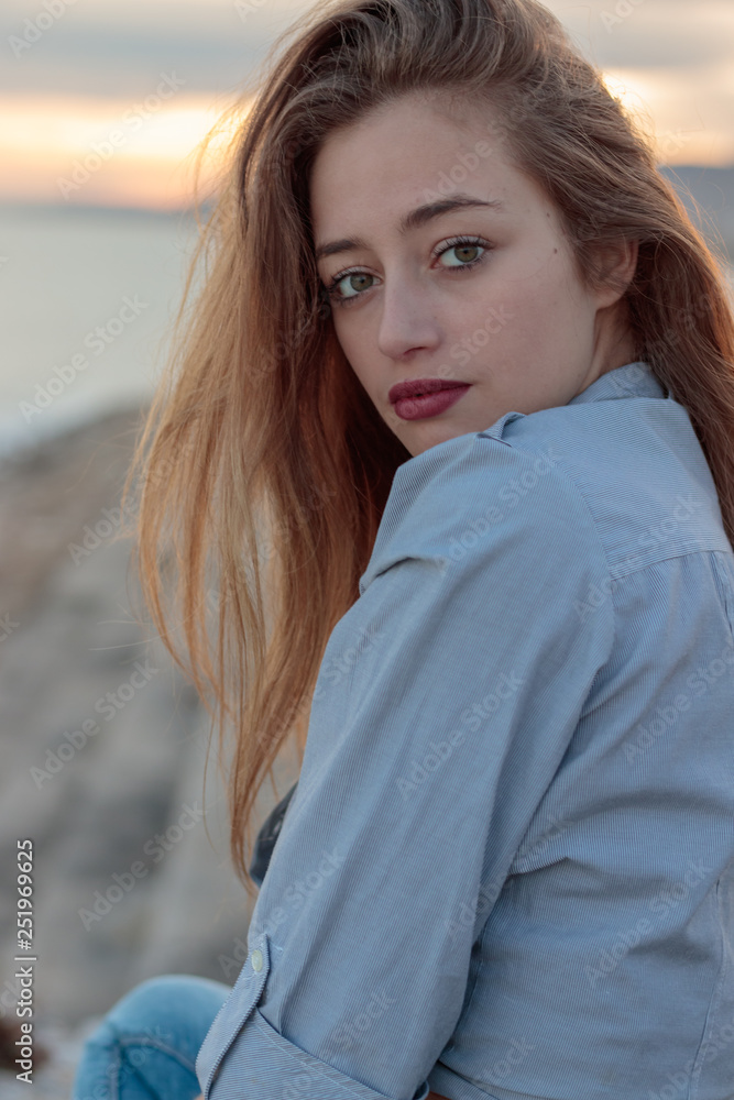 Young woman during the sunset in the mediterranean Young woman during the sunset in the mediterranean