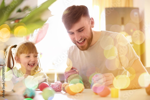 Father painting Easter eggs...