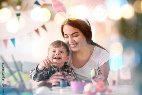 Mother painting Easter eggs...
