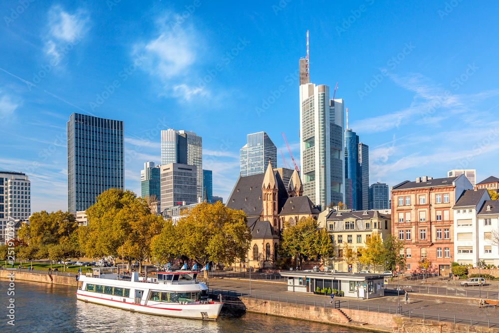 Obraz premium Cityscape skyline of business district with skyscrapers and cruise ship during sunny day in Frankfurt am Main. Hessen, Germany