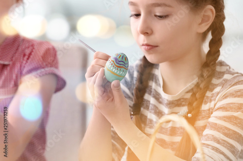 Cute little girl painting e...