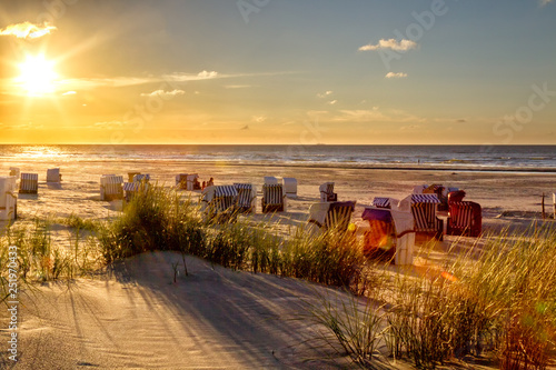 Sunset on the beach of the north sea island Juist in East Frisia, Germany, Europe. photo