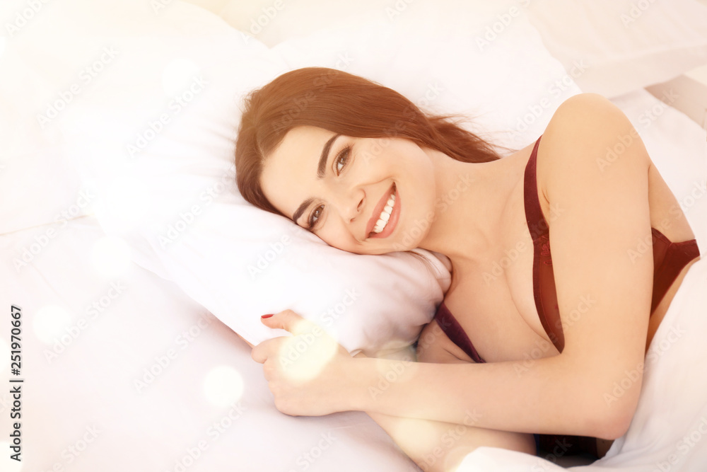 Morning of beautiful young woman lying in bed at home Morning of beautiful young woman lying in bed at home