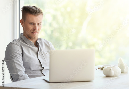 Handsome freelancer with la...