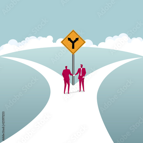  Businessmen shake hands at the fork road. Business cooperation concept.