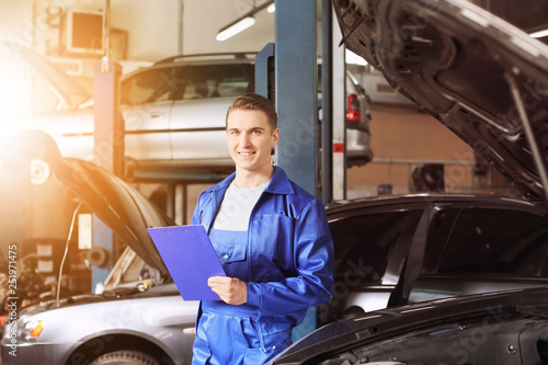 Male mechanic with clipboar...