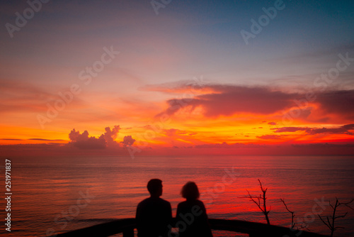 date of a loving couple seat on backgrond of amazing scarlet sunset in Bali