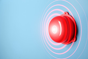 Modern alarm bell on color background