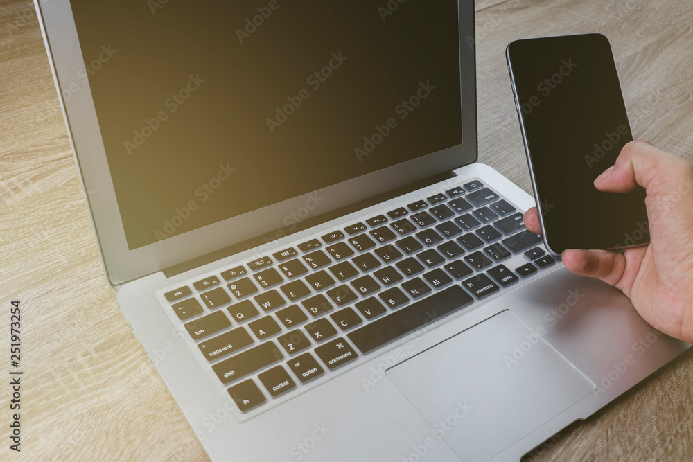 handing smart-phone creative new business concept with laptop getting ideas, cross process and soft flare filter handing smart-phone creative new business concept with laptop getting ideas, cross process and soft flare filter