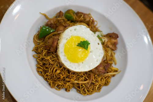 Dry instant noodle with egg ,chicken and green pepper . Asian delicacies foods .