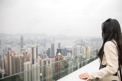Photography Pensive girl looking at the city on a foggy day