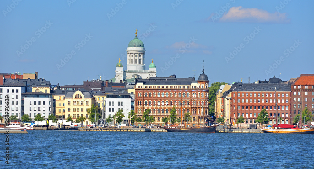 Pohjoisranta embankment, harbor with yacht and ships on background of Finnish Evangelical Lutheran cathedral of Diocese. Helsinki. Suomi