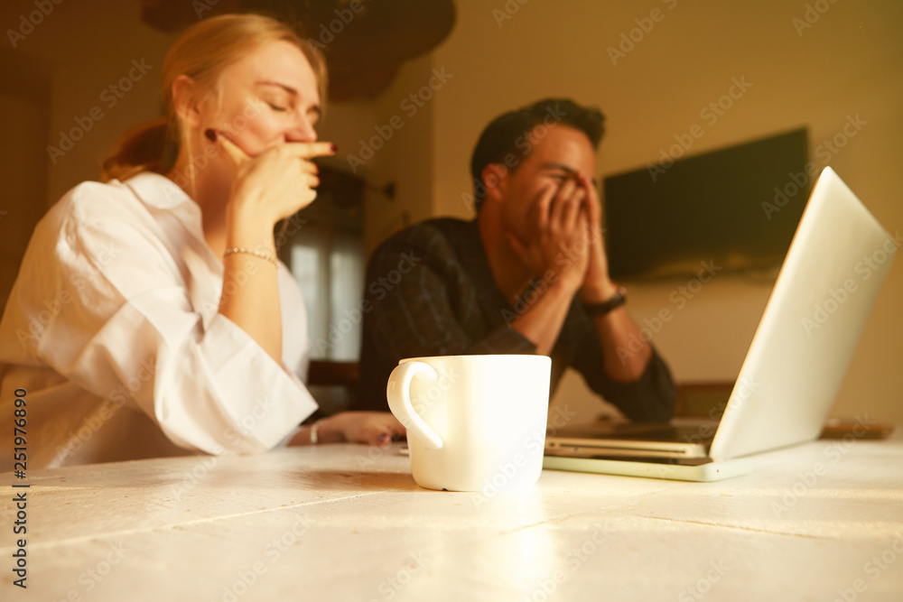 Happy couple doing business together working at small office on the laptop. Happy couple doing business together working at small office on the laptop.