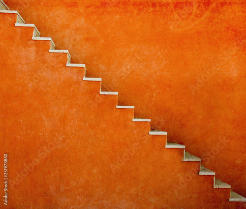 Orange wall with stairs texture background, minimalistic style for base image for posters, banners or covers, trivial design and simplicity is a trendy key for graphic arts, acid psychedelic color