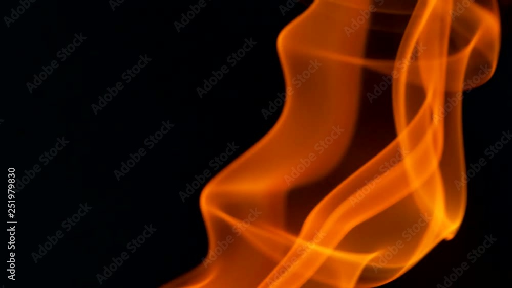 Thin trickle of fiery orange-red smoke slowly rising graceful twists up on black background. Colored smoke blowing from bottom to top. Closeup Thin trickle of fiery orange-red smoke slowly rising graceful twists up on black background. Colored smoke blowing from bottom to top. Closeup