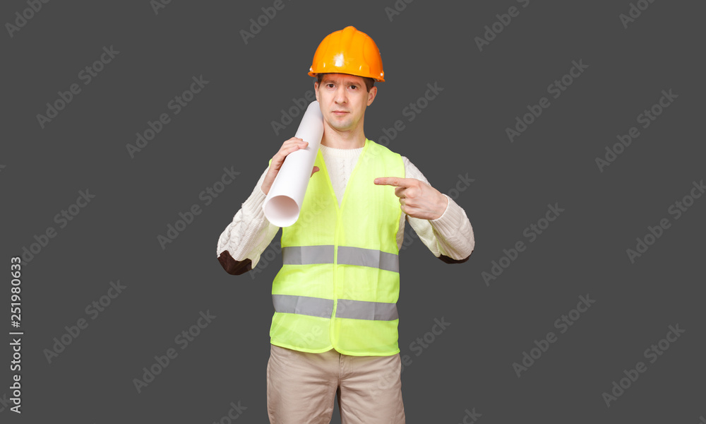 the civil engineer in a helmet points a finger at documents the civil engineer in a helmet points a finger at documents