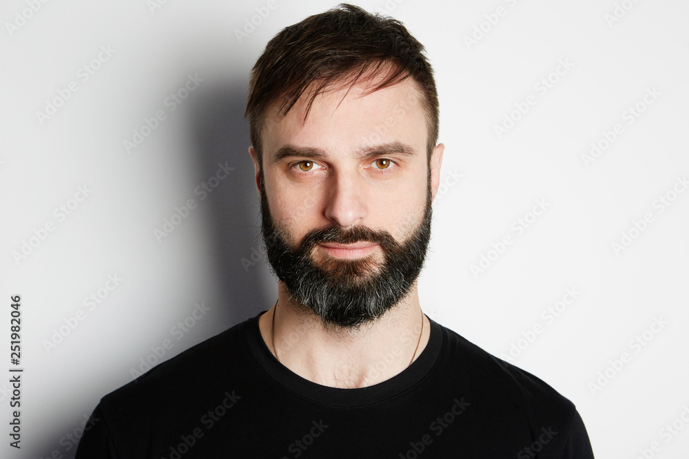 Portrait of bearded man in black tshirt on the empty background. Portrait of bearded man in black tshirt on the empty background.
