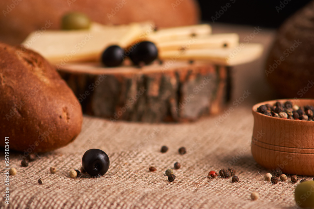 olive is on the table in background of bread, baguette and cheese. Selective focus olive is on the table in background of bread, baguette and cheese. Selective focus