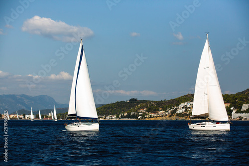 Sailing boats participate in sail yacht regatta around Saronic Islands in Aegean Sea - Greece.
