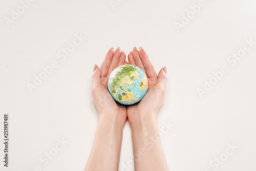 cropped view of female holding earth model on white background, global warming concept