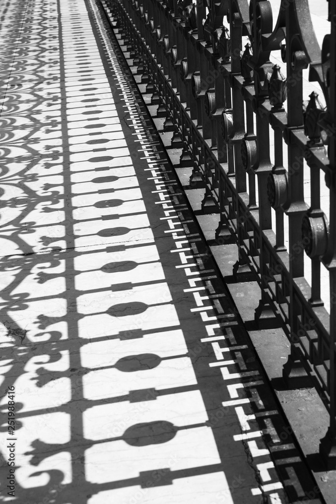 Fototapeta premium The shadow of the metal fencing bridge