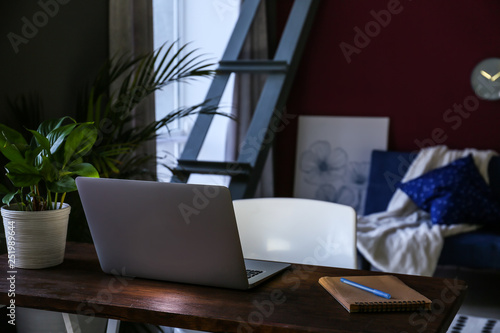 Workplace with laptop in stylish interior of room © Pixel-Shot
