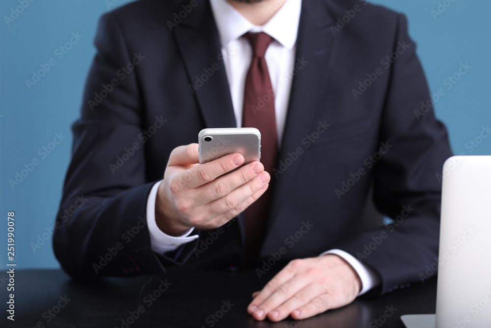 Businessman using mobile phone in office, closeup Businessman using mobile phone in office, closeup