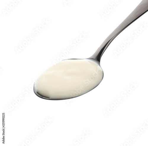 Spoon with tasty yogurt on white background photo